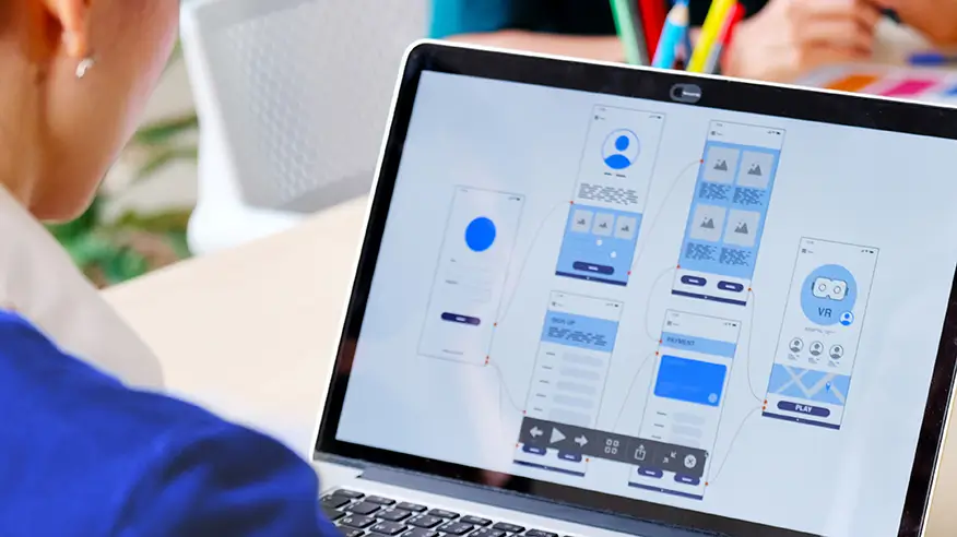 A woman staring at a computer screen filled with different icons.